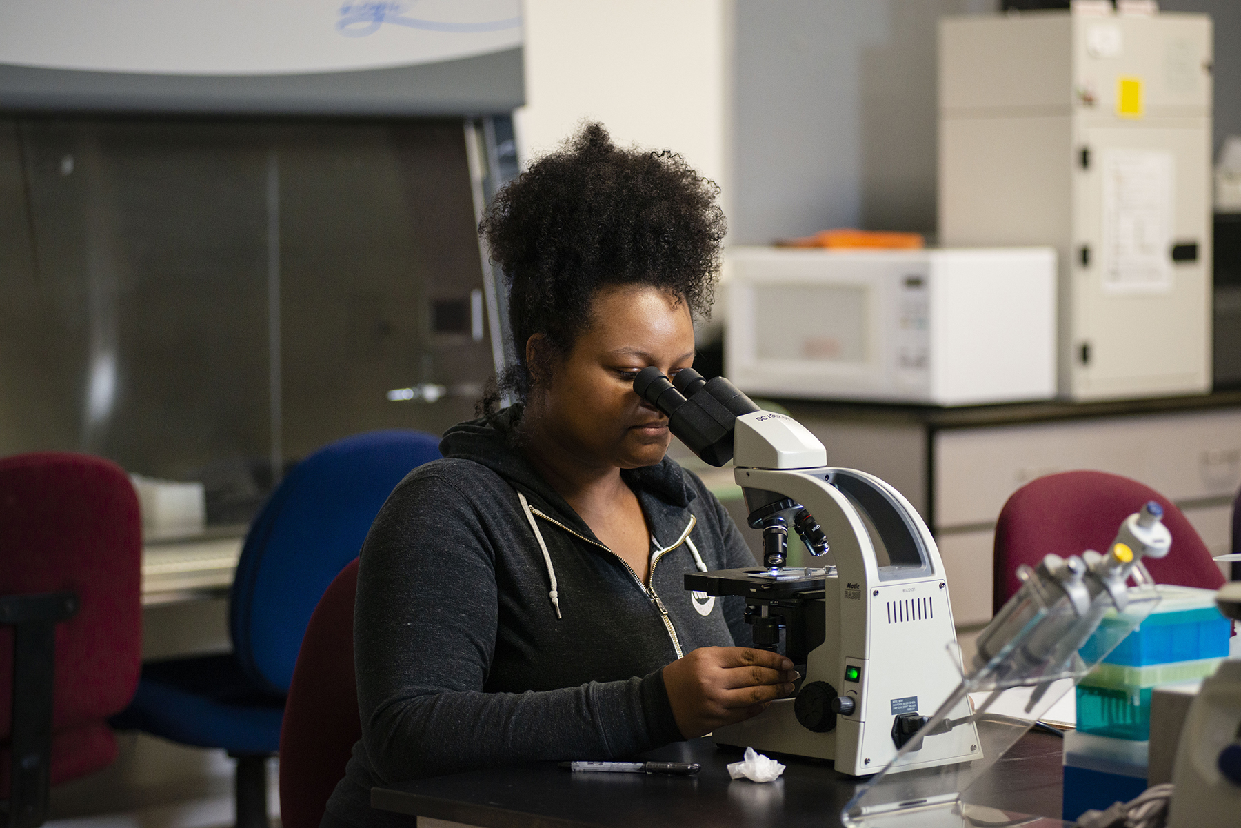 Student looking into microscope
