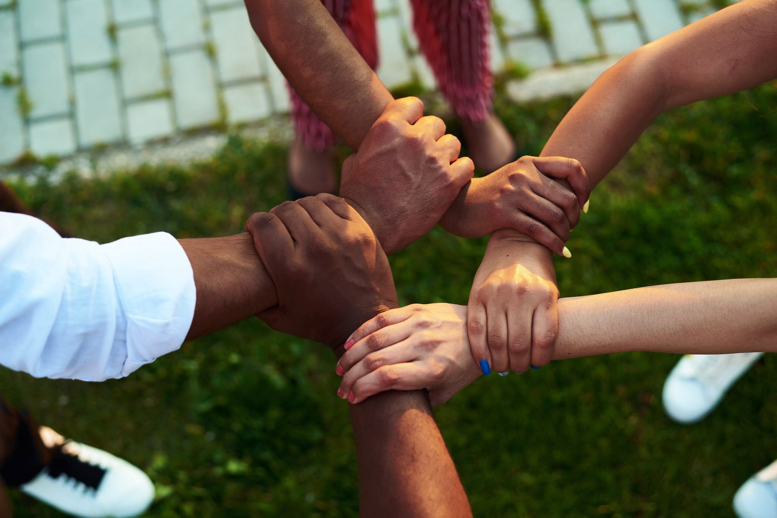 People with hands joined to show unity and diversity.