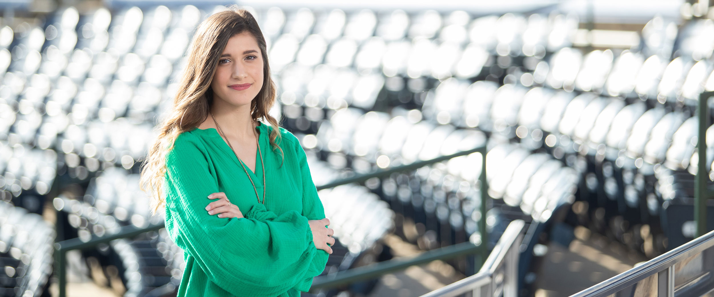 A student from Georgia Southern's B.S. in Sport Management program stands among stadium seats.