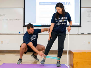 A student in Georgia Southern's Kinesiology, Exercise Science Concentration, M.S. Program learns about new exercise techniques.