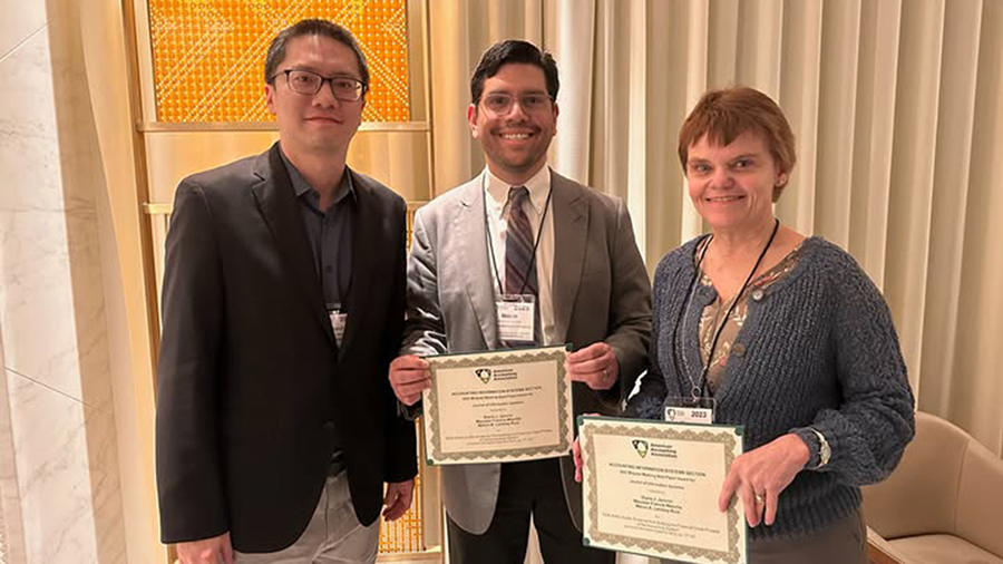 Melvin, Associate Professor of Accounting, honored with the Award of Excellence.