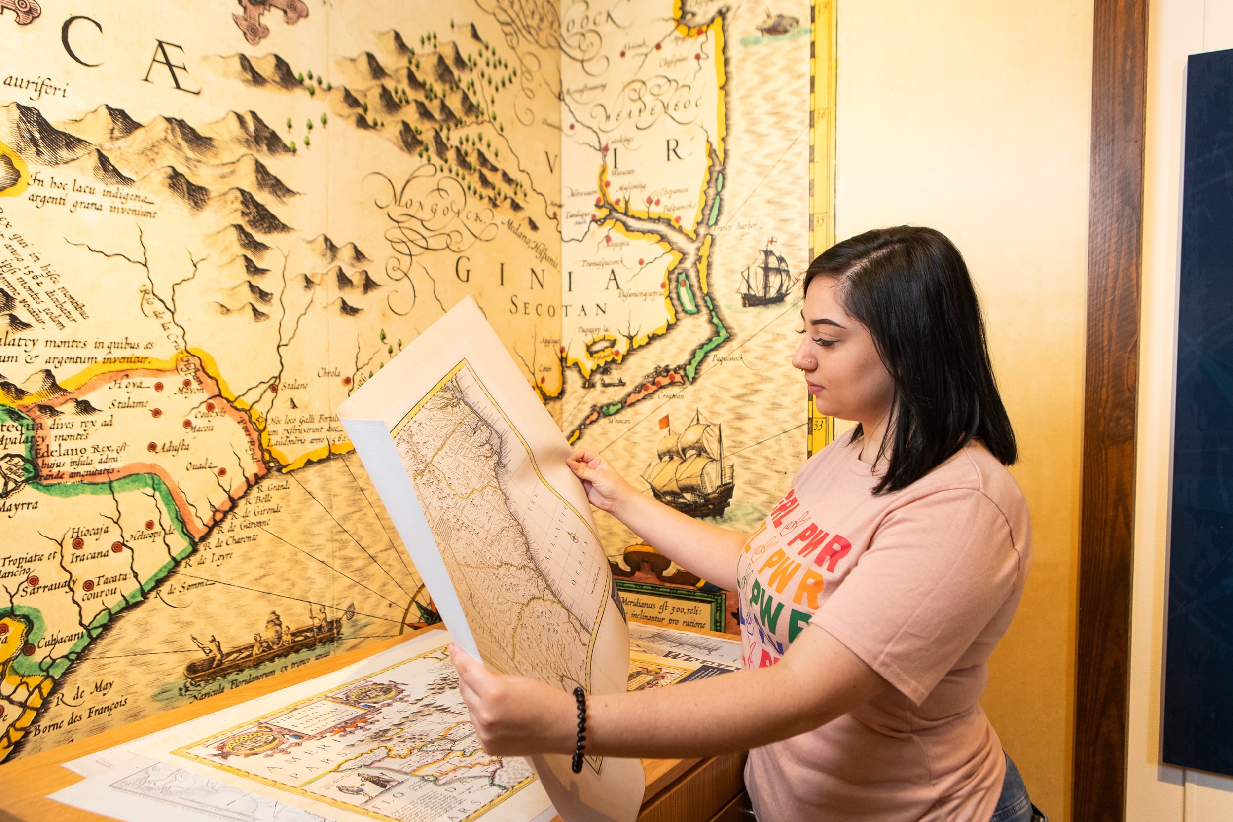 A Georgia Southern student examines maps and landscapes to better understand historical sites for anthropology.
