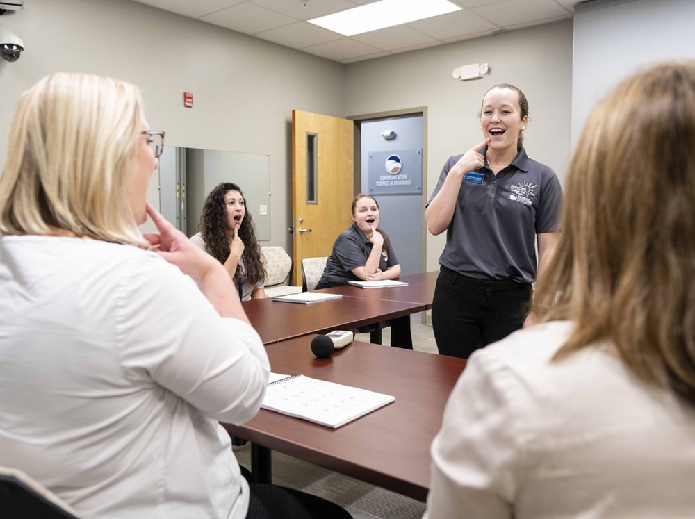 An instructor in communication sciences and disorders for Georgia Southern teaches students during a practicum.
