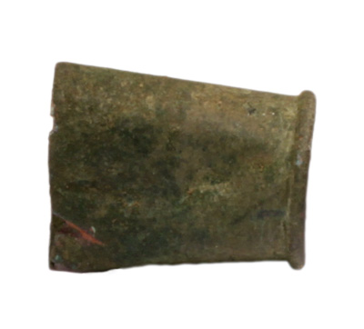 A brass artifact that looks like a smashed shell casing.