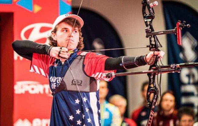 Adam Heidt shoots a bow during a competition