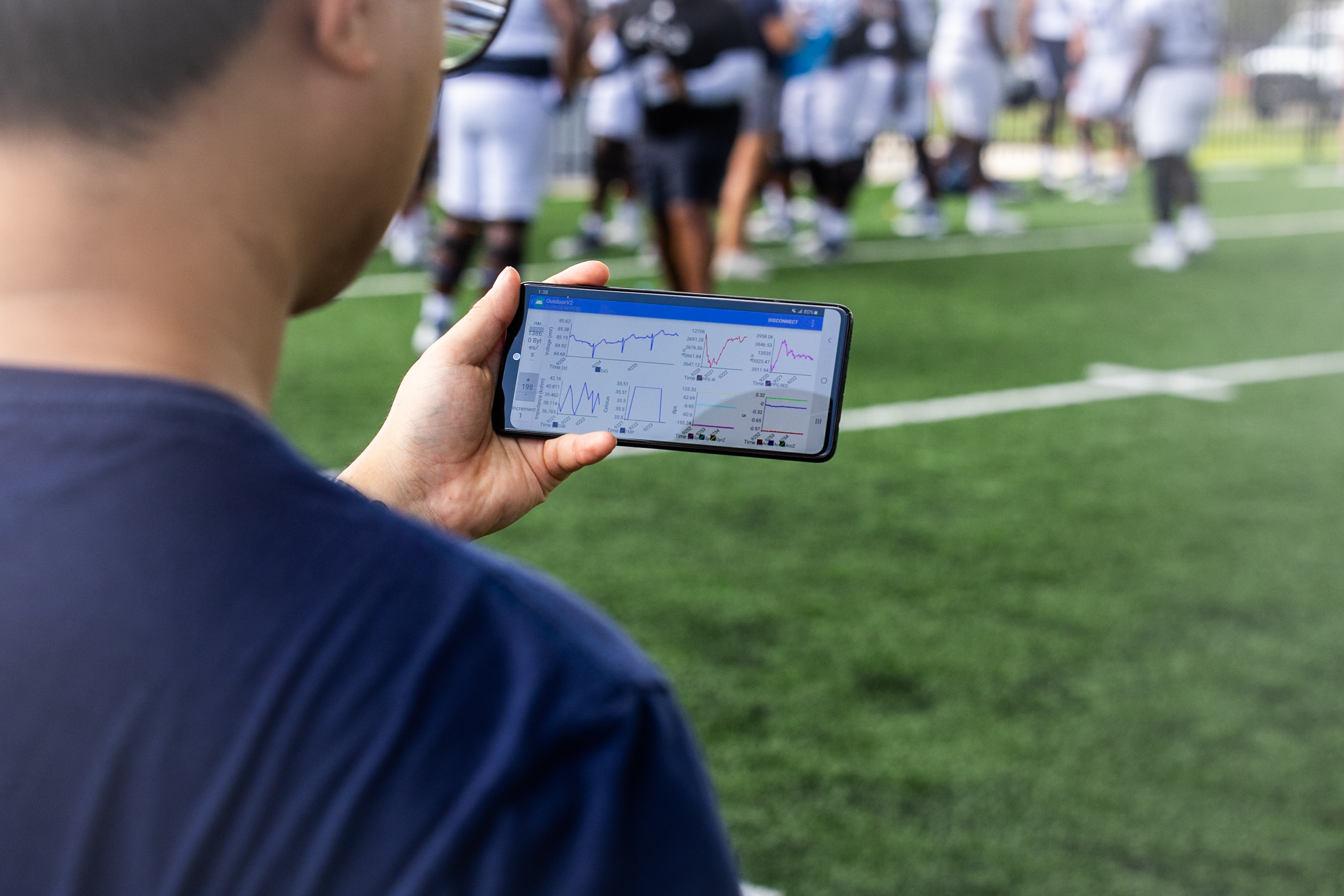 Georgia Tech Postdoctoral Researcher Taewoog Kang, Ph.D., analyzes results from the patch during a Georgia Southern Football Practice, fall 2025