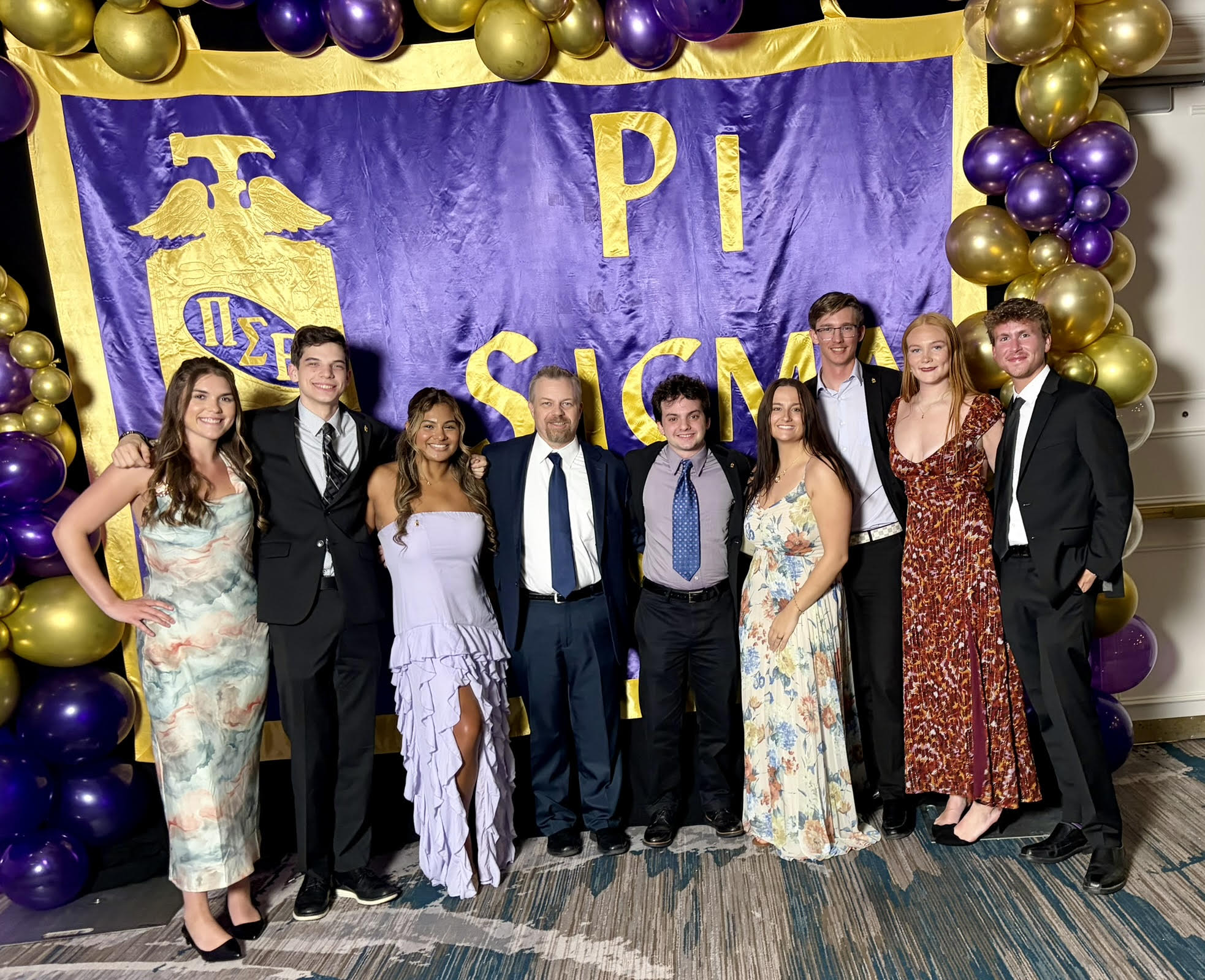 Georgia Southern students from the Parker College of Business stand with Professor Travis Brickey at the Pi Sigma Epsilon National Convention