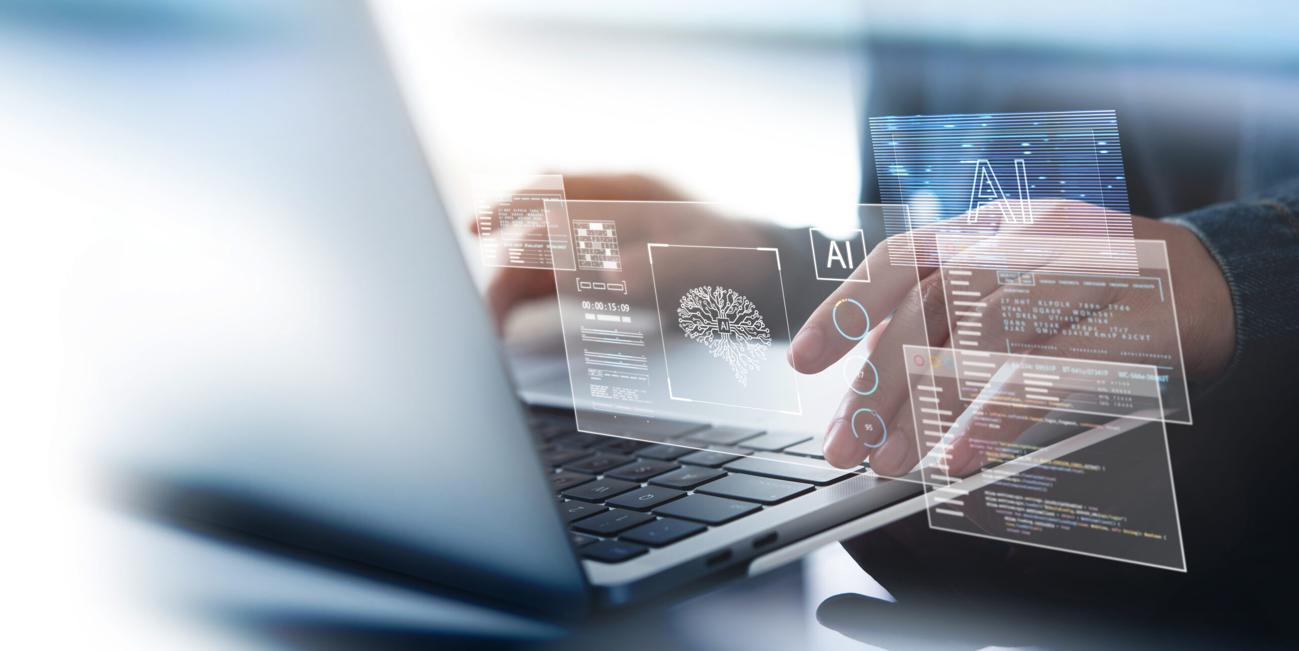 Hands typing on a laptop with translucent holographic AI data panels floating above the keyboard.