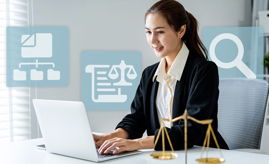 Female lawyer typing on a laptop with scales of justice icons in the background.