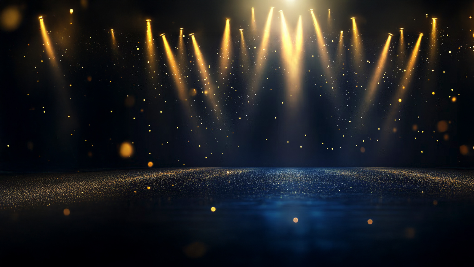 Golden stage lights beam down onto a dark, glittering floor, with scattered bokeh particles floating in the air.